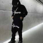 person wearing black tracksuit urban style
