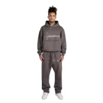 person wearing dark grey tracksuit